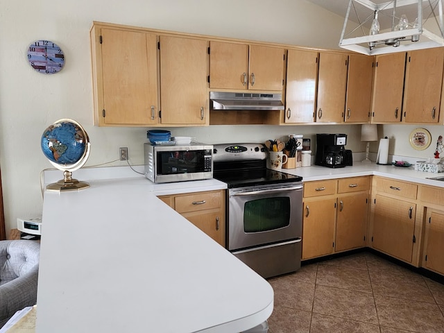 kitchen featuring dark tile patterned flooring and stainless steel appliances