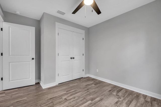 1695 Landing St, Carrabelle, FL 32322 - unfurnished bedroom with wood finished floors, a closet, and a ceiling fan