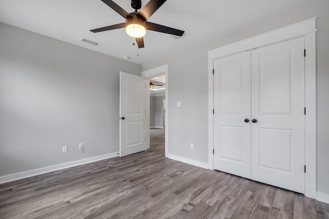 1695 Landing St, Carrabelle, FL 32322 - unfurnished bedroom with wood finished floors, a closet, and a ceiling fan