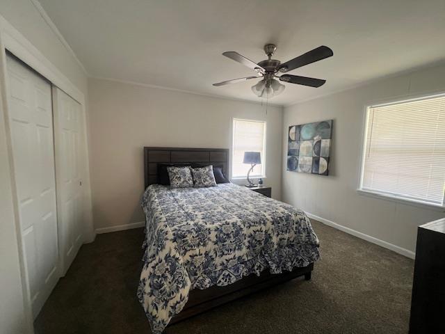 carpeted bedroom with a closet and ceiling fan