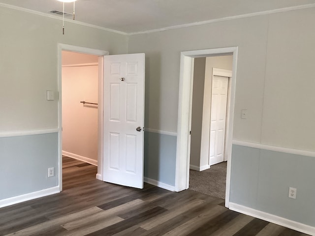 spare room featuring dark hardwood / wood-style flooring and ornamental molding