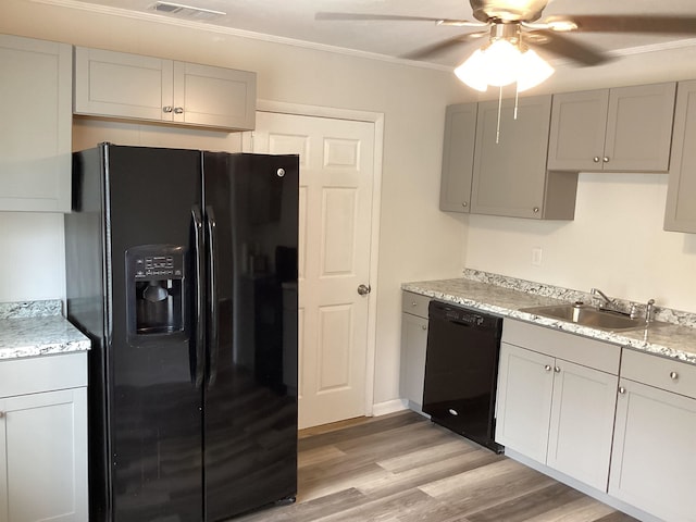 kitchen with gray cabinetry, black appliances, sink, ornamental molding, and light hardwood / wood-style floors