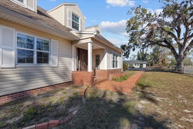 view of property exterior with a yard