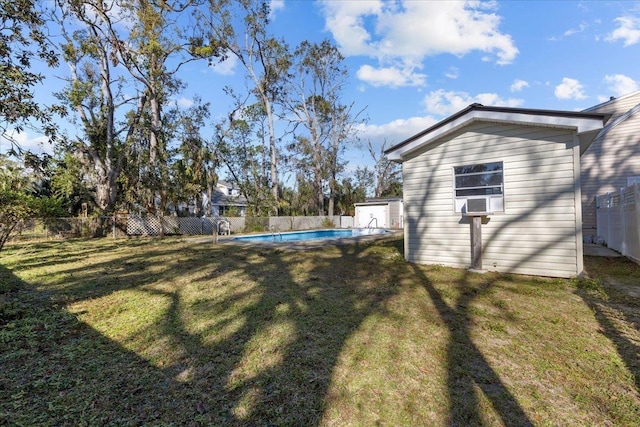 view of yard with a storage unit and a fenced in pool