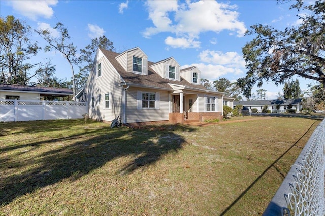 new england style home featuring a front lawn