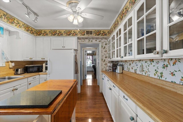 kitchen with white cabinetry, dark hardwood / wood-style floors, and white refrigerator