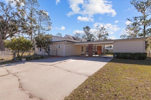 ranch-style home with a front yard and a carport