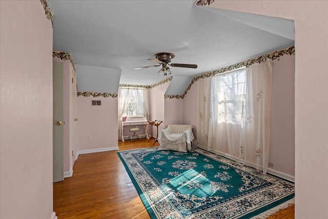 living area featuring hardwood / wood-style flooring, plenty of natural light, and ceiling fan