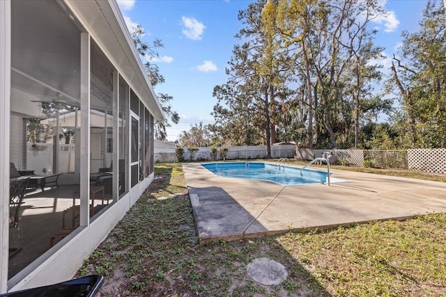 view of swimming pool with a sunroom and a patio