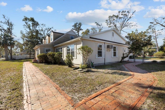 view of side of property with a yard