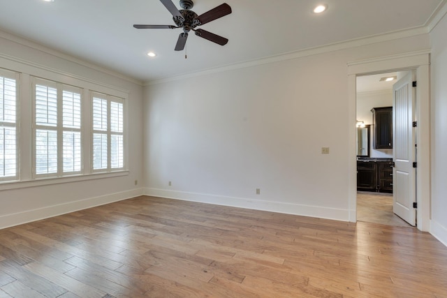 unfurnished room with light wood finished floors, ornamental molding, recessed lighting, and baseboards