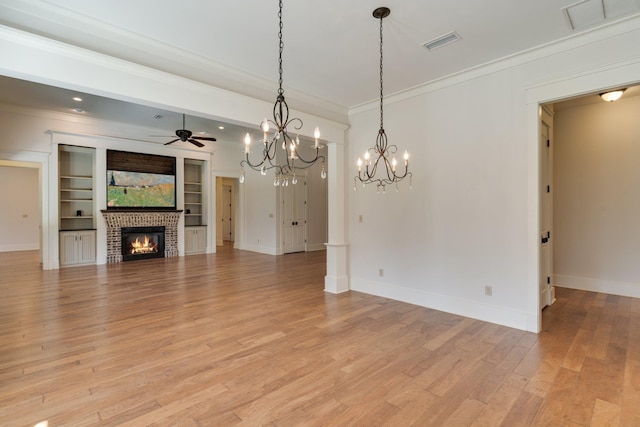 unfurnished living room featuring a brick fireplace, visible vents, crown molding, and light wood finished floors