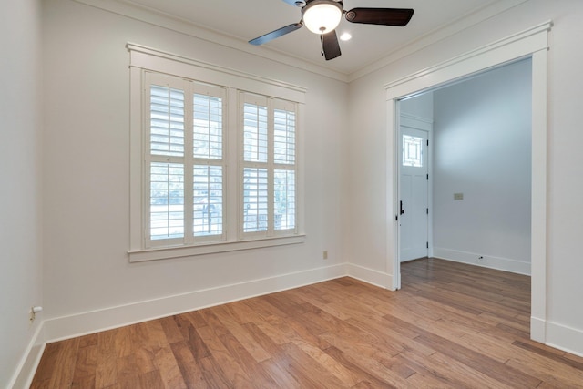 unfurnished room with ornamental molding, plenty of natural light, and light wood-style floors