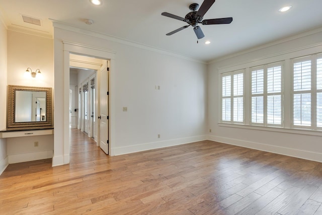 unfurnished room featuring baseboards, visible vents, crown molding, and light wood finished floors