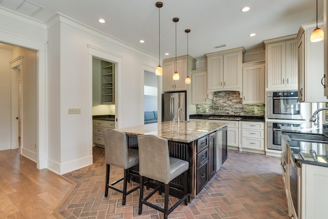 kitchen featuring cream cabinets, brick floor, ornamental molding, appliances with stainless steel finishes, and decorative backsplash