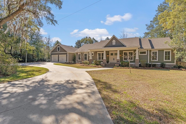 view of front of property featuring a garage, concrete driveway, and a front yard