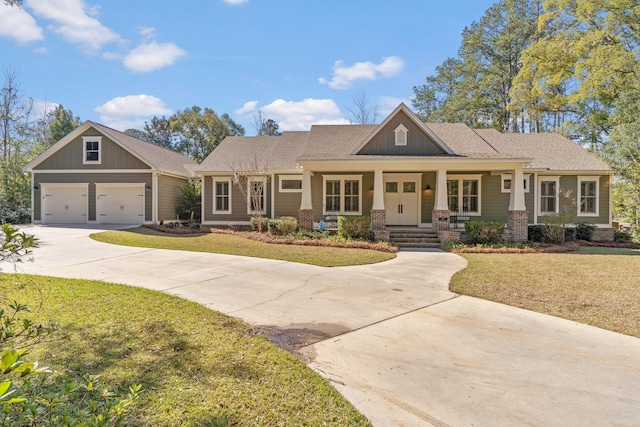 view of front of property with driveway, a porch, a front lawn, and board and batten siding