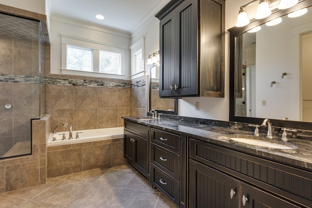 full bathroom featuring tile patterned flooring, a sink, a tile shower, a bath, and crown molding