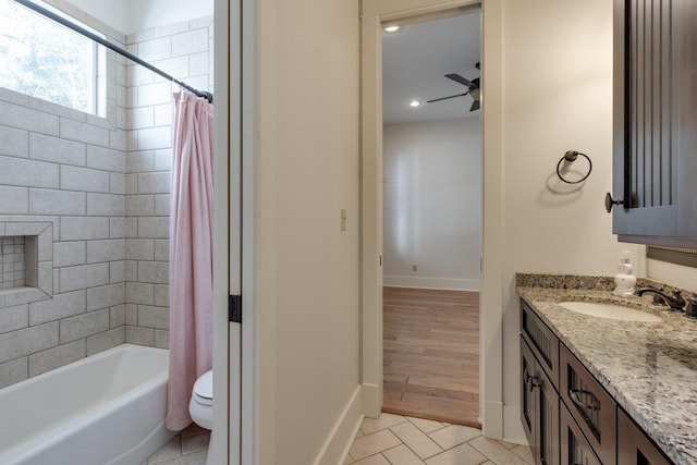 bathroom with shower / bath combination with curtain, toilet, a ceiling fan, vanity, and tile patterned flooring