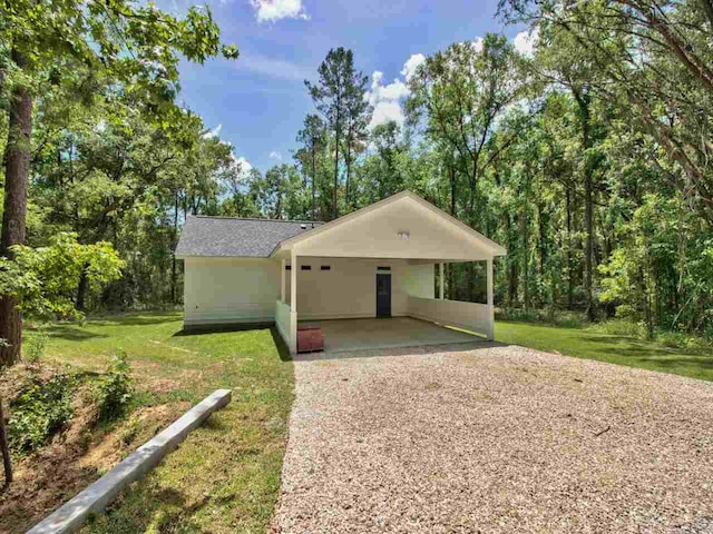 exterior space with a carport and a front lawn