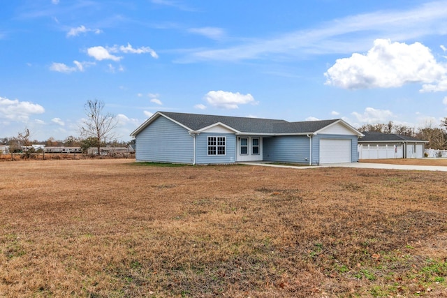 single story home featuring a garage and a front yard