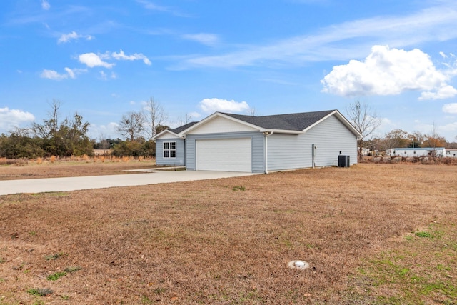 view of property exterior with a garage, a lawn, and central air condition unit