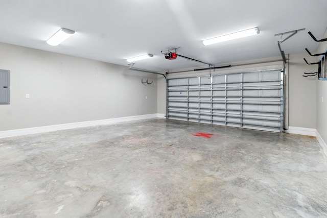 garage with a garage door opener and electric panel