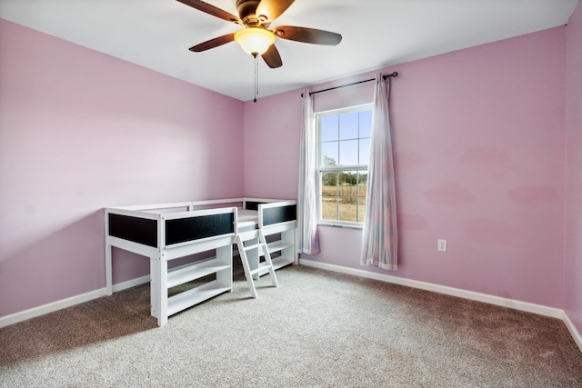 unfurnished bedroom featuring ceiling fan and carpet flooring