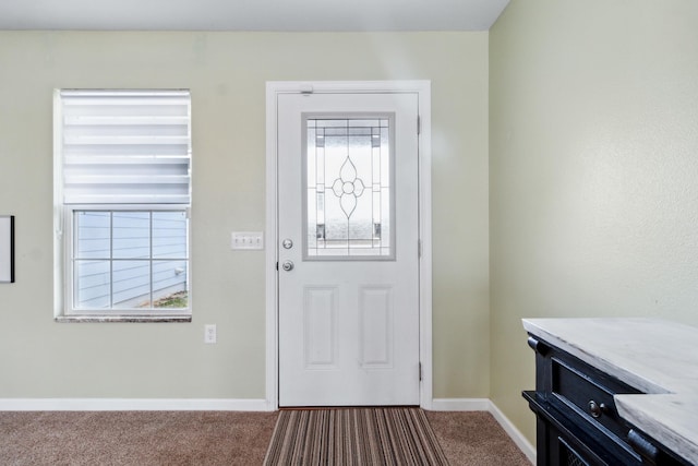 foyer entrance with carpet floors