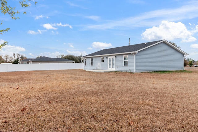 rear view of house with a patio area and a lawn