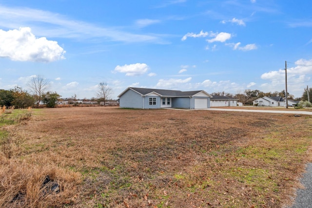 single story home featuring a garage and a front yard