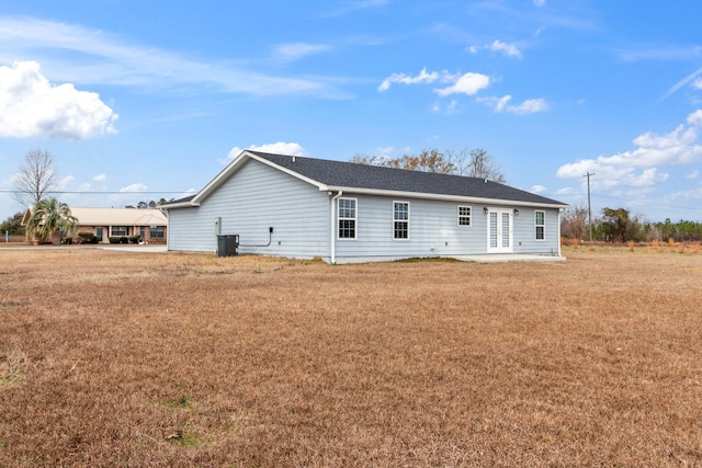 rear view of house featuring cooling unit, a yard, and a patio area