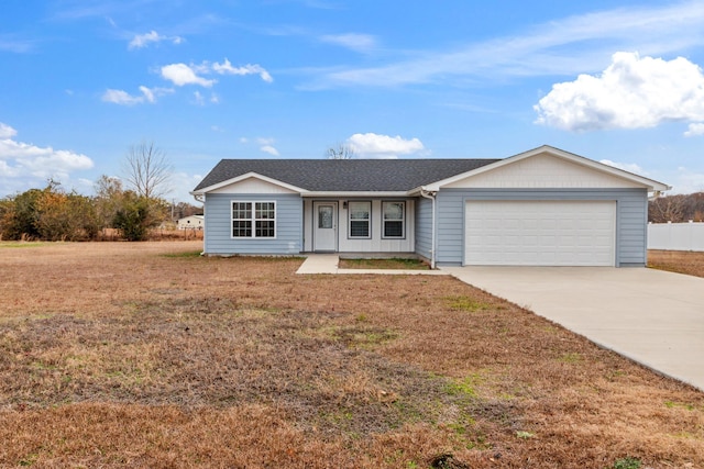 ranch-style home featuring a garage and a front lawn