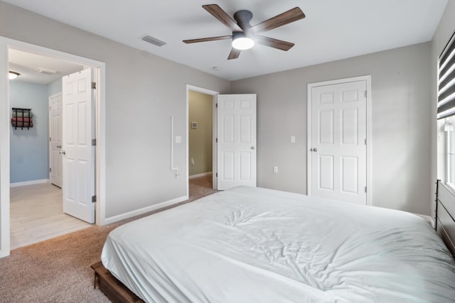 bedroom featuring light colored carpet and ceiling fan