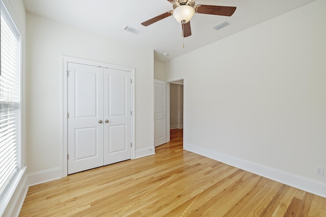 unfurnished bedroom featuring ceiling fan, a closet, and light hardwood / wood-style flooring