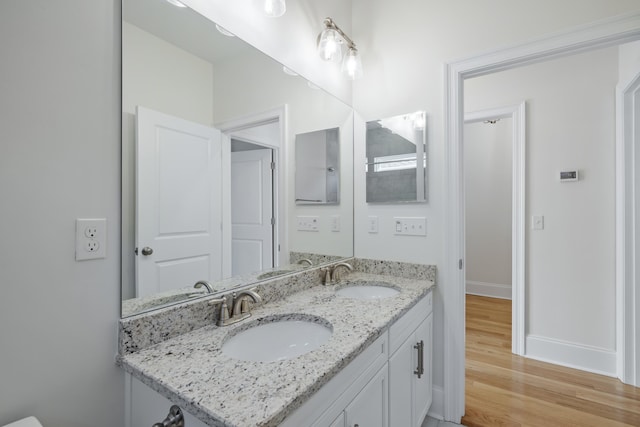 bathroom featuring hardwood / wood-style flooring and vanity