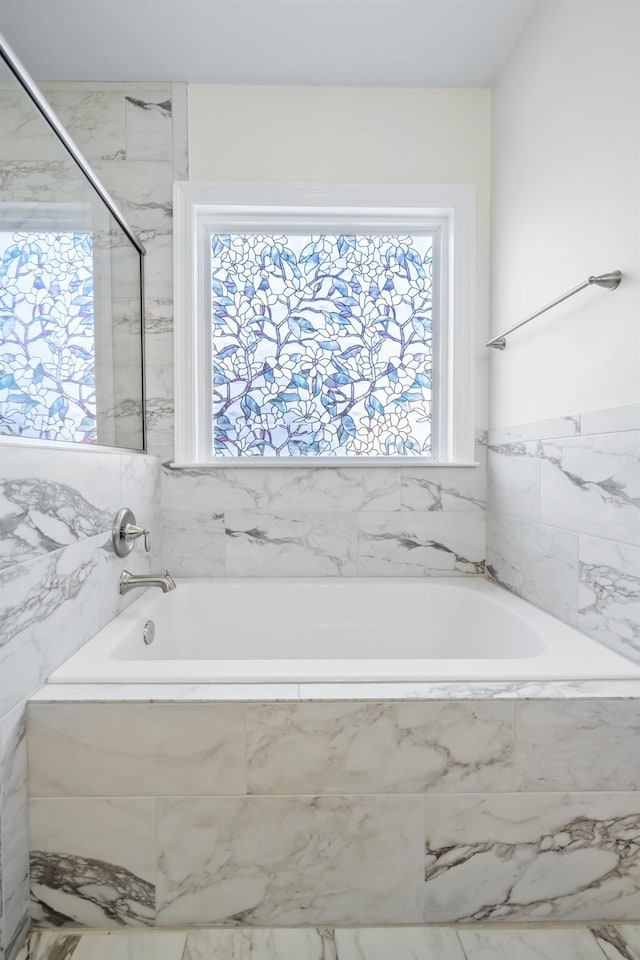 bathroom featuring tiled bath