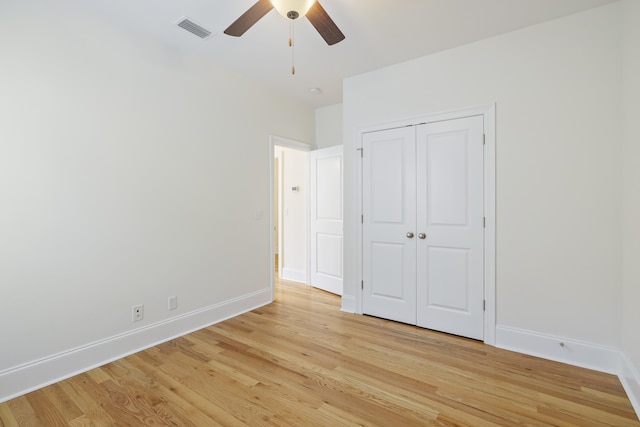 unfurnished bedroom featuring a closet, ceiling fan, and light hardwood / wood-style flooring