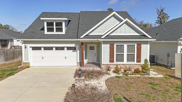 craftsman inspired home featuring central AC unit and a garage