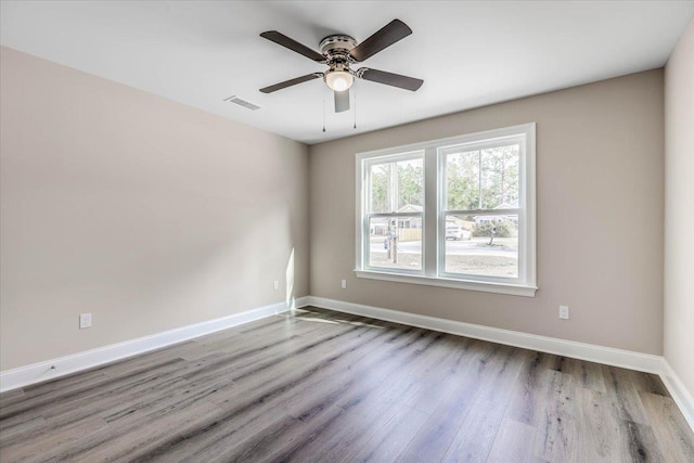 spare room featuring ceiling fan and hardwood / wood-style floors