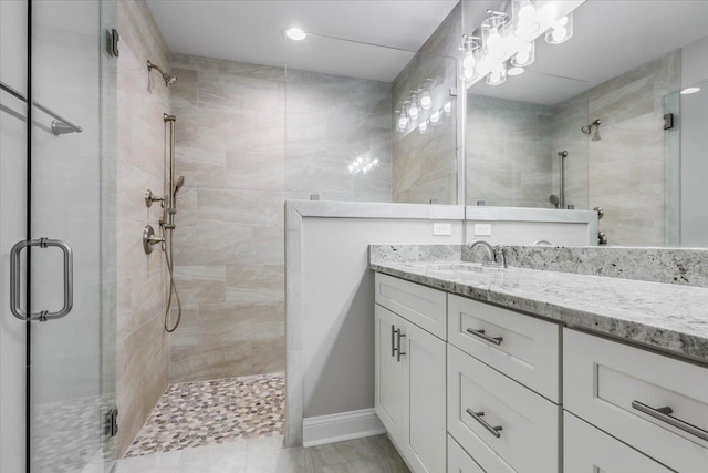 bathroom featuring vanity and a shower with shower door