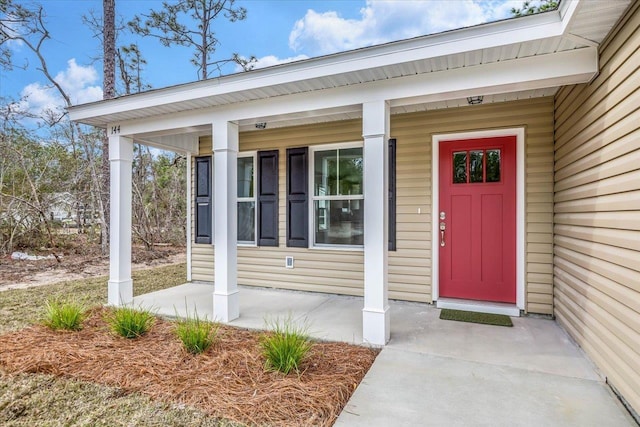 view of exterior entry with covered porch