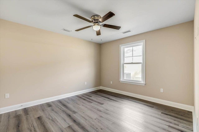 spare room featuring light hardwood / wood-style floors and ceiling fan