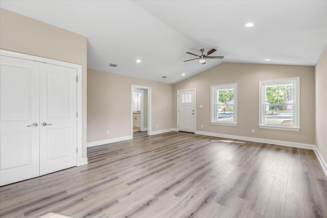 unfurnished living room featuring ceiling fan, vaulted ceiling, and light hardwood / wood-style flooring