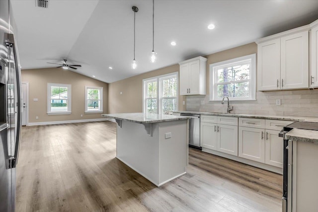 kitchen with white cabinetry, appliances with stainless steel finishes, sink, and hanging light fixtures