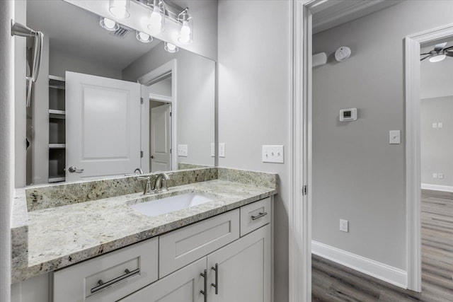 bathroom featuring ceiling fan, vanity, and hardwood / wood-style floors