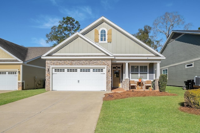 5852 Bascom Dr, Tallahassee, FL 32309 - craftsman-style house featuring board and batten siding, a porch, driveway, a front lawn, and stone siding