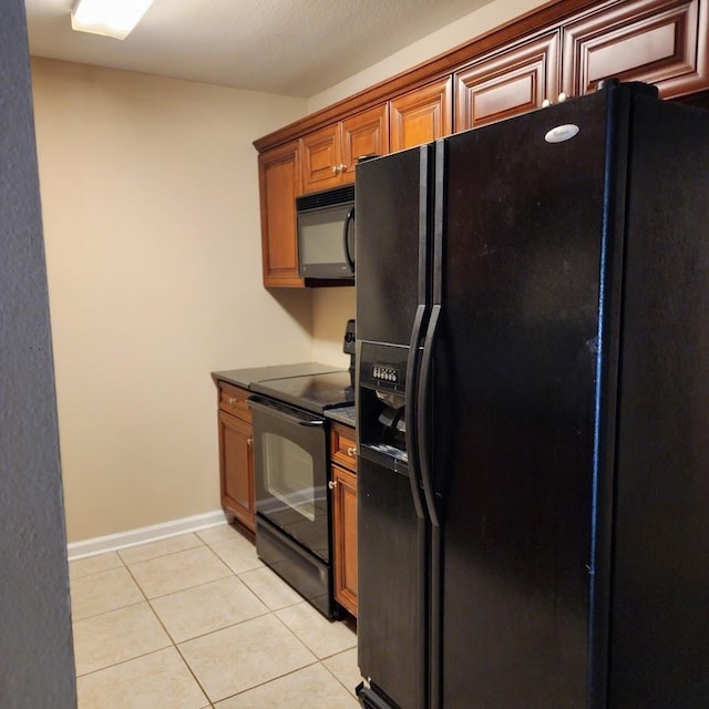 kitchen featuring light tile patterned floors and black appliances