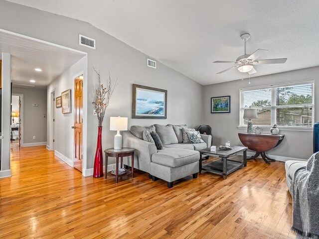 living room featuring light wood-type flooring, ceiling fan, and lofted ceiling