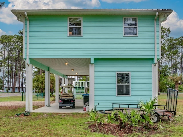 rear view of house with a yard